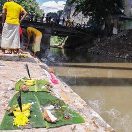 Photograph of offerings left at the river at Thaipusam - on the base of the banana leave there is a part of the coconut shell, bananas, flowers and incenses, photo by Ivan Kralj