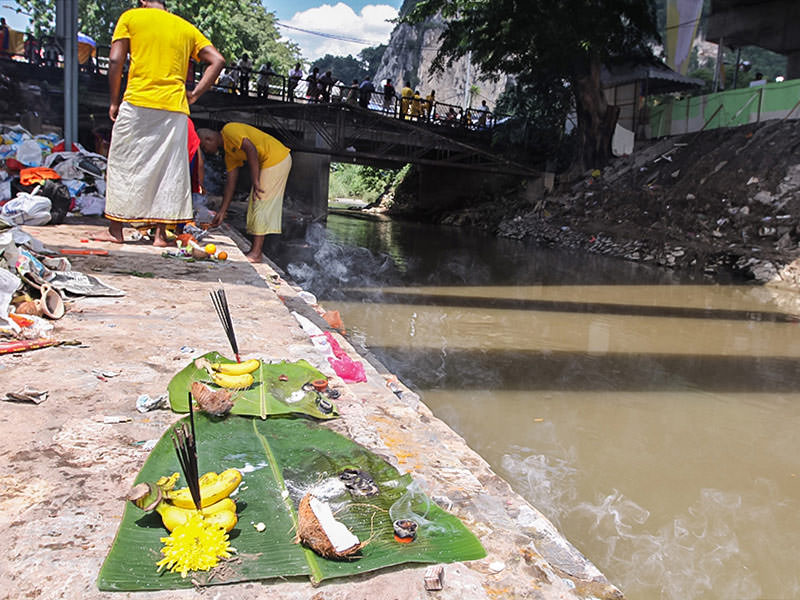 Photograph of offerings left at the river at Thaipusam - on the base of the banana leave there is a part of the coconut shell, bananas, flowers and incenses, photo by Ivan Kralj