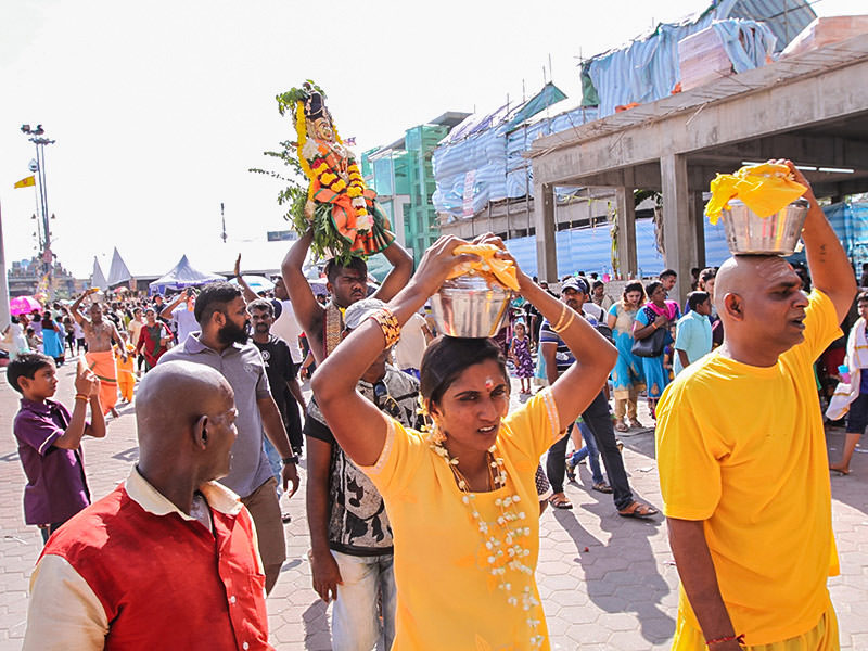 Photograph of pilgrims carrying Paal Kudam, brass pots filled with milk, as offerings for Thaipusam festival, photo by Ivan Kralj
