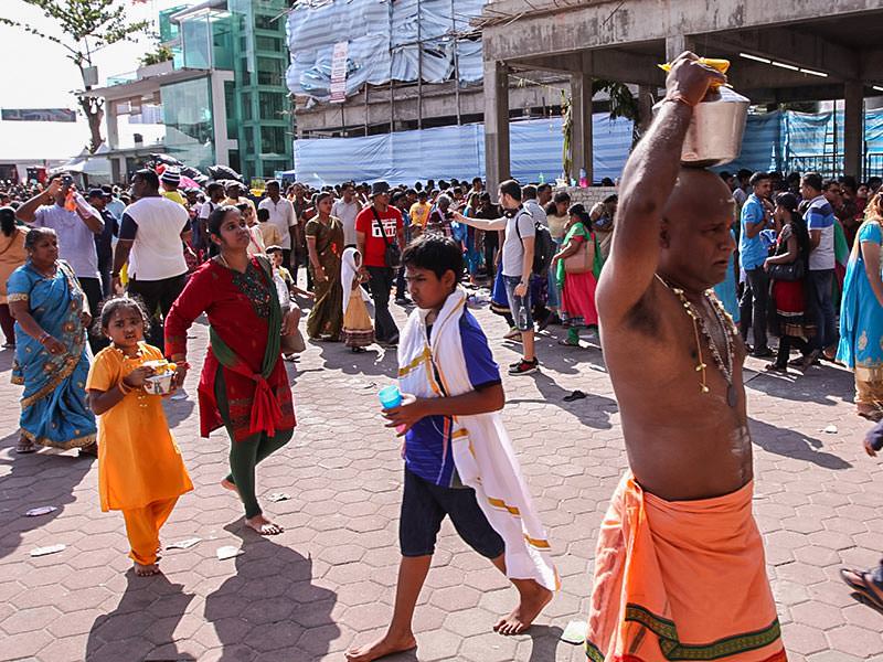 Photograph of pilgrims carrying Paal Kudam, brass pots filled with milk, as offerings for Thaipusam festival, photo by Ivan Kralj