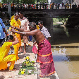 Photograph of the family father putting the Paal Kudam at his family member's head after the ritual at the river at Thaipusam, photo by Ivan Kralj