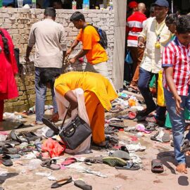 Photograph of a woman searching for her shoes at the entrance of one of the temples at Batu Caves - with million and half of visitors at Thaipusam shoes get easily lost, photo by Ivan Kralj