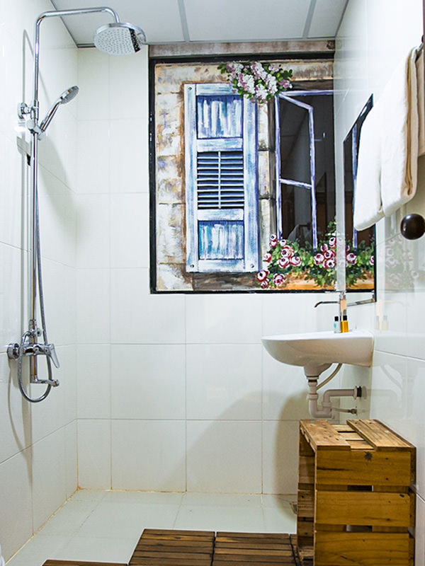 Photo of the bathroom in The Laban hotel, with shower, sink, wooden box, painting of the window on the wall, photo by Ivan Kralj