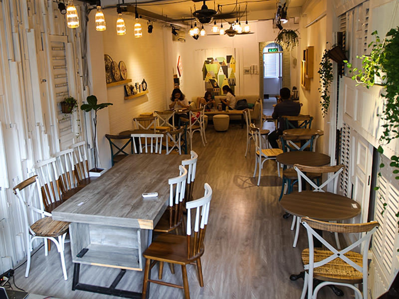 The photo of a mezzanine in The Laban hotel, lounge place with tables and chairs and couch with several people sitting and using their mobile phones, photo by Ivan Kralj