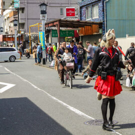 Crossdresser is walking down the street and clearing it up from people for the penis parade at Kanamara Matsuru, festival of the iron penis, in Kawasaki, Japan, photo by Ivan Kralj