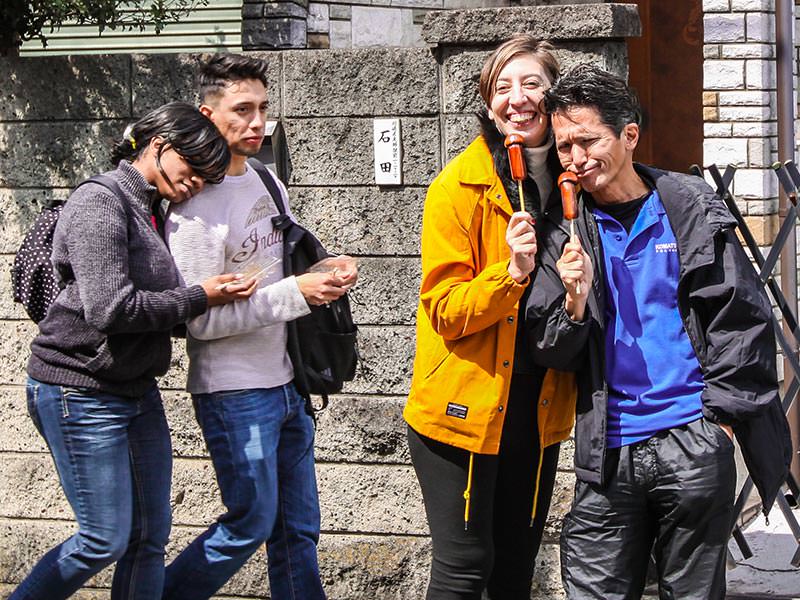 A couple posing with penis-shaped lollipops at Kanamara Matsuru, festival of the iron penis, in Kawasaki, Japan, photo by Ivan Kralj