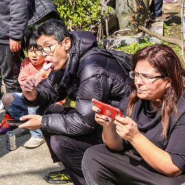 A man is suggestively sucking on a penis-shaped lollipop at Kanamara Matsuru, festival of the iron penis, in Kawasaki, Japan, photo by Ivan Kralj