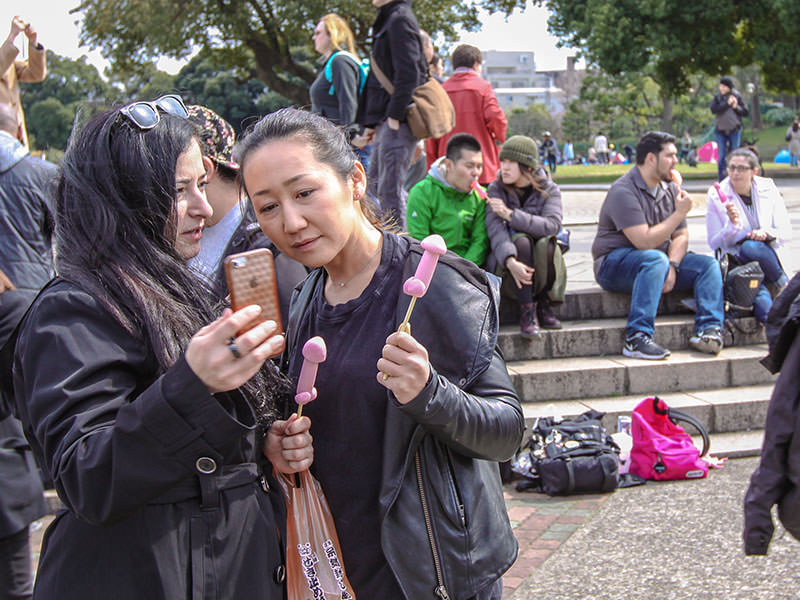 People licking penis and vagina shaped lollipops at Kanamara Matsuru, festival of the iron penis, in Kawasaki, Japan, photo by Ivan Kralj
