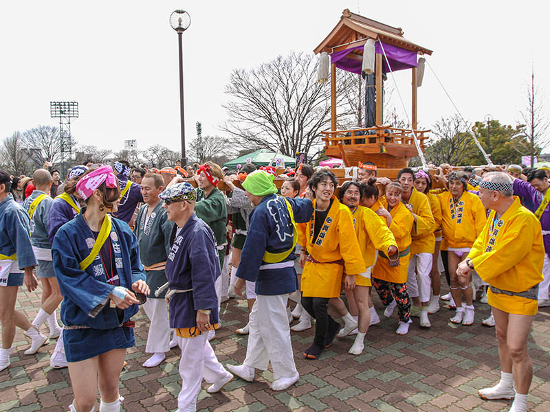 Group of worshippers carrying the mikoshi, portable shrine at Kanamara Matsuru, festival of the iron penis, in Kawasaki, Japan, photo by Ivan Kralj