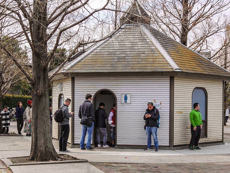 Men waiting in the line for the loo at Kanamara Matsuru, festival of the iron penis, in Kawasaki, Japan, photo by Ivan Kralj