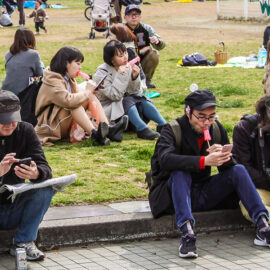 People licking penis-shaped lollipops in the park in Kawasaki, Japan, during the Kanamara Matsuri, festival of the iron penis, photo by Ivan Kralj
