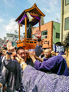 Shinto worshippers carrying the portable shrine called mikoshi, with a giant steel penis sculpture, at Kanamara Matsuri, japanese Fesstival of the Iron Phallus in Kawasaki, photo by Mladen Koncar