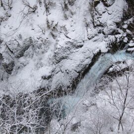 Kegon Falls' water making its way through the snowy surrounding, birds eye perspective, Japan, photo by Ivan Kralj