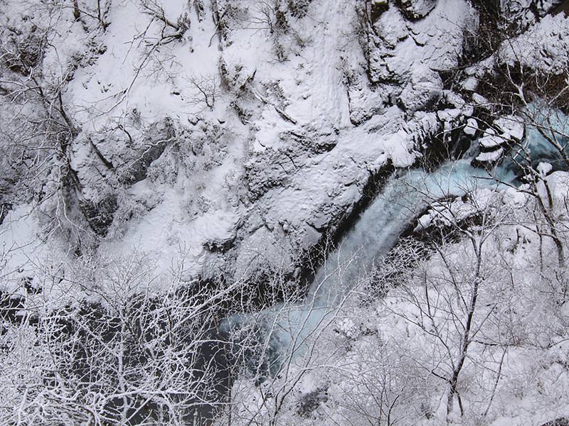 Kegon Falls' water making its way through the snowy surrounding, birds eye perspective, Japan, photo by Ivan Kralj