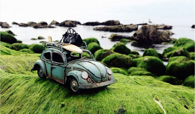 Vintage Volkswagen toy car on the shore, photo by Kim Leuenberger