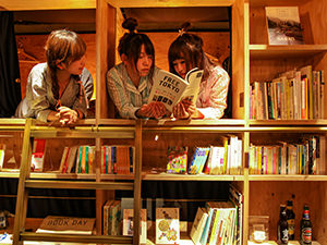 Japanese girls reading books in the bookshelf dormitory in Book and Bed hostel in Tokyo, Japan, photo by Ivan Kralj
