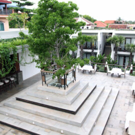 Jaya House River Park hotel terrace, with a tree protruding the roof from the restaurant below, in Siem Reap, Cambodia, photo by Ivan Kralj