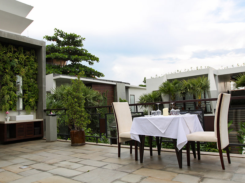 Jaya House River Park hotel terrace, with a dinner table set for two, in Siem Reap, Cambodia, photo by Ivan Kralj