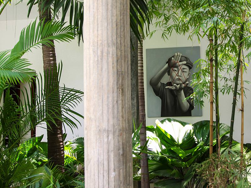 Painting by Christian Develter surrounded by greenery at Rambutan Resort Phnom Penh, Cambodia, photo by Ivan Kralj