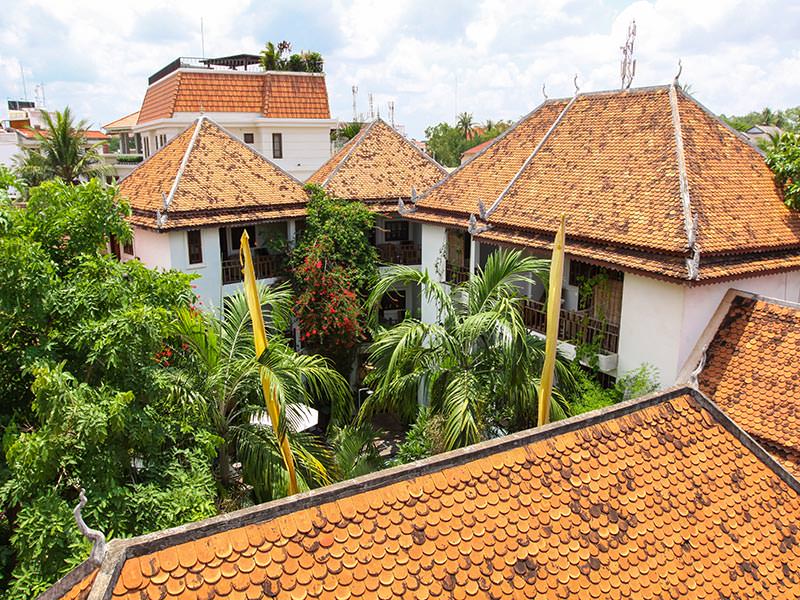 Red-tiled roof and green courtyard at Rambutan Resort Siem Reap, Cambodia, photo by Ivan Kralj