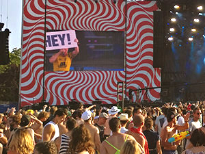 Audience of Dubioza Kolektiv in front of the big video screen at Sziget Festival in Budapest, Hungary, the artists is holding a sign saying "Hey!", photo by Ivan Kralj