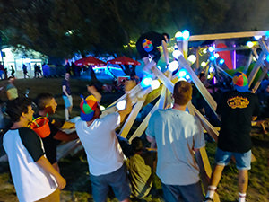 Sziget Festival visitors gather around the art installation of enlarged light matches, watching one of them climbing the artwork, photo by Ivan Kralj