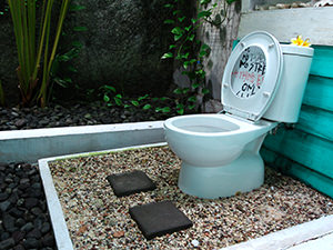 Outdoor toilet with pebbles under the toilet seat, in Beach Room of Abrakadabra Artbnb, one of the best hostels of Java, in Yogyakarta, Indonesia, photo by Ivan Kralj