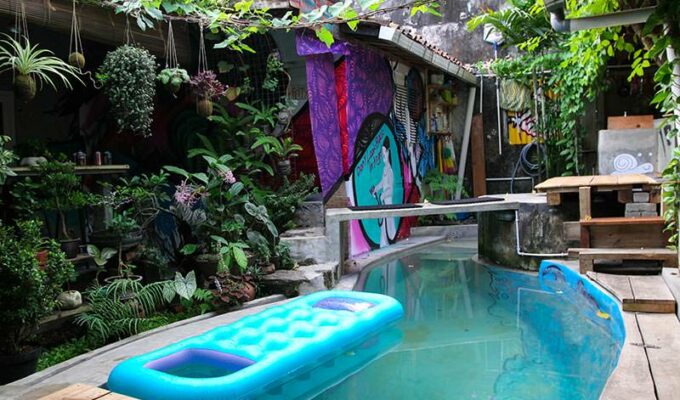 Small swimming pool, surrounded with plants and graffiti, as a central point of Abrakadabra Artbnb, one of the best hostels of Java, in Yogyakarta, Indonesia, photo by Ivan Kralj