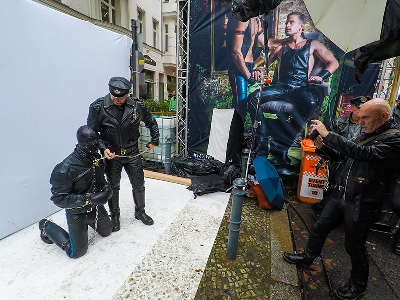 Leather man with a mask-covered slave on a leash at Folsom Europe Street Fair, the biggest European gay fetish event, in Berlin, Germany, photo by Ivan Kralj