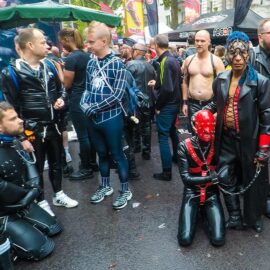 Leather man with a mask-covered slave on a leash at Folsom Europe Street Fair, the biggest European gay fetish event, in Berlin, Germany, photo by Ivan Kralj