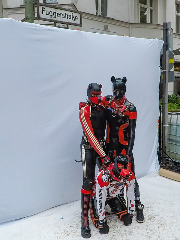 Three human puppies posing for a photo at Folsom Europe Street Fair, the biggest European gay fetish event, in Berlin, Germany, photo by Ivan Kralj