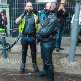 A man smoking a cigar and the slave holding an ashtray with his mouth at Folsom Europe Street Fair, the biggest European gay fetish event, in Berlin, Germany, photo by Ivan Kralj