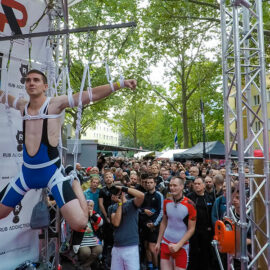 People watching the shibari performance, a man tied in shibari style, hanging at Folsom Europe Street Fair, the biggest European gay fetish event, in Berlin, Germany, photo by Ivan Kralj