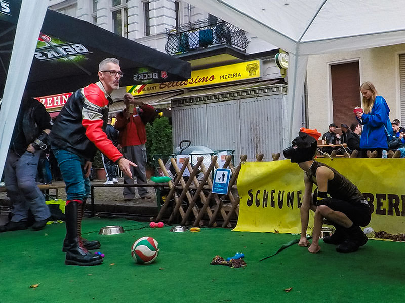 A man is throwing a dildo for a human puppy to fetch it at Folsom Europe Street Fair, the biggest European gay fetish event, in Berlin, Germany, photo by Ivan Kralj