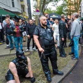 Leather cigar man with a human puppy on a leash at Folsom Europe Street Fair, the biggest European gay fetish event, in Berlin, Germany, photo by Ivan Kralj