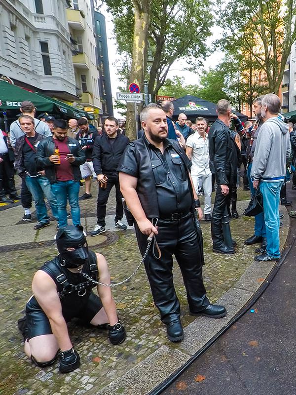 Leather cigar man with a human puppy on a leash at Folsom Europe Street Fair, the biggest European gay fetish event, in Berlin, Germany, photo by Ivan Kralj