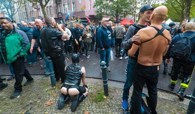 Leather cigar man with a human puppy on a leash at Folsom Europe Street Fair, the biggest European gay fetish event, in Berlin, Germany, photo by Ivan Kralj