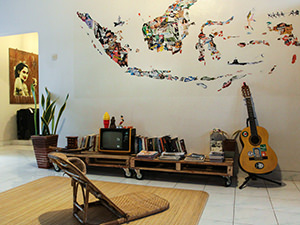 Lounge room with a guitar, analog TV and retro details in Sae Sae, one of the best hostels of Java, in Yogyakarta, Indonesia, photo by Ivan Kralj