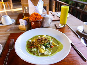 Bubur Ayam, Balinese-style porridge, with Jamu Kunyit, turmeric herb juice, served for breakfast at Sankara Ubud Resort, one of the answers to where to stay in Bali, Indonesia, photo by Ivan Kralj