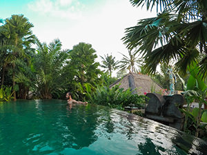 Infinity swimming pool surrounded by lush vegetation at Sankara Resort in Ubud, one of the answers to where to stay in Bali, Indonesia, photo by Ivan Kralj