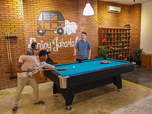 Guests playing billiard in the lobby of Wonderloft, one of the best hostels of Java, in Jakarta, Indonesia, photo by Ivan Kralj