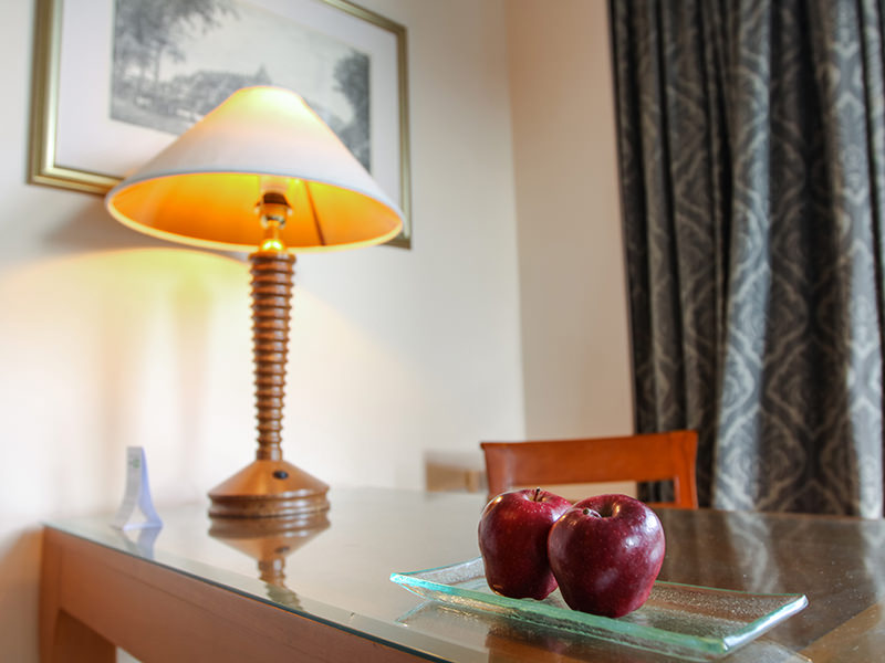 Two red apples and a lamp at the table in the room at Hyatt Regency Yogyakarta hotel in Jogjakarta, Indonesia, photo by Ivan Kralj