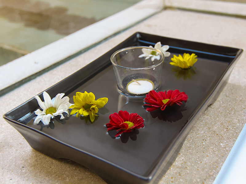 The decorative flowers floating in the plate with water and candle in the bathroom of the private pavilion at the Balé resort in Nusa Dua, Bali, Indonesia, photo by Ivan Kralj