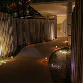 Futuristic pathway surrounded by metal tubes, water and candles, at the entrance to the Balé resort in Nusa Dua, Bali, Indonesia, photo by Ivan Kralj