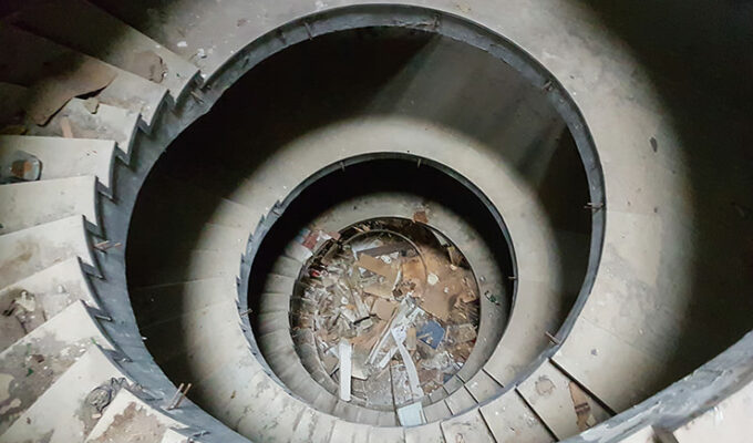 Circular staircase with a debris in the abandoned Belvedere Hotel Dubrovnik, Croatia, photo by Benjamin Martin