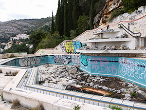 The graffiti and garbage covered swimming pool at the abandoned Hotel Belvedere Dubrovnik, Croatia, photo by Ivan Kralj