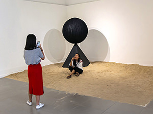 Two girls interacting with the exhibits in Galeri Nasional Indoensia, while taking selfies, in Jakarta, Indonesia, photo by Ivan Kralj