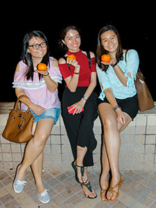 Three young Malaysian women posing with mandarin oranges on which they wrote their names, wishes and phone numbers before throwing them into the sea, hoping that Mr. Right would pick them up on Chap Goh Mei, Chinese Valentine's Day, in George Town, Penang, Malaysia, photo by Ivan Kralj