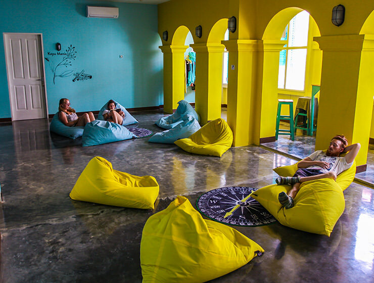 Guests resting on the blue and yellow beanbags in the lounge of Wonderloft hostel in Jakarta, Indonesia, photo by Ivan Kralj