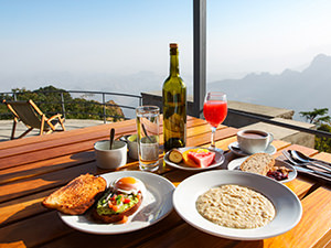 Rich breakfast served on the terrace of Limalimo Lodge with stunning views of Simien Mountains, photo by Ivan Kralj